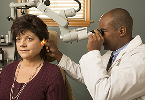 Doctor examining patient's ear.