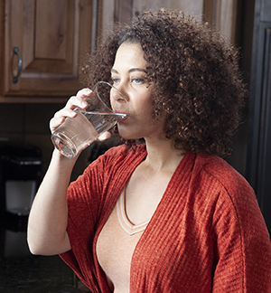 Woman drinking glass of water.